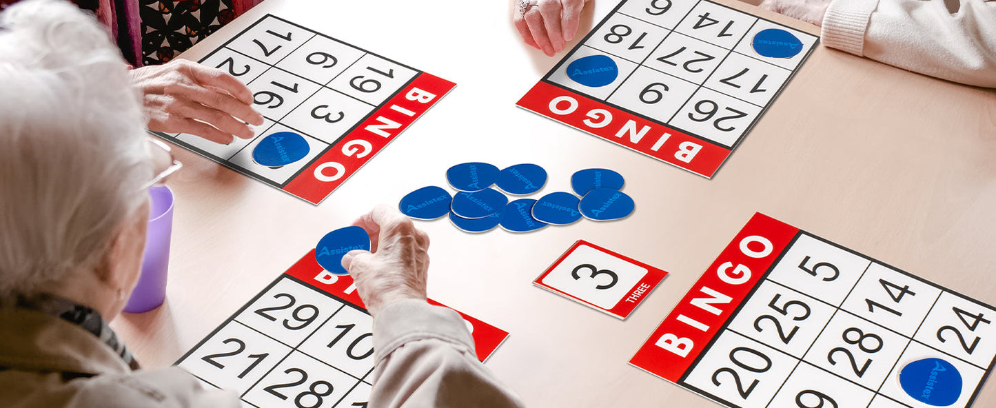 Flat lay of Assistex Bingo for Seniors game components including bingo cards and chips — Assistex via EOWD Autism Living