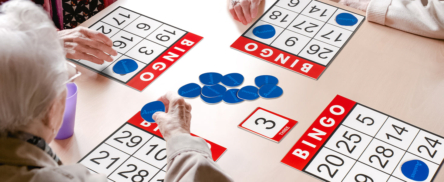 Flat lay of Assistex Bingo for Seniors game components including bingo cards and chips — Assistex via EOWD Autism Living