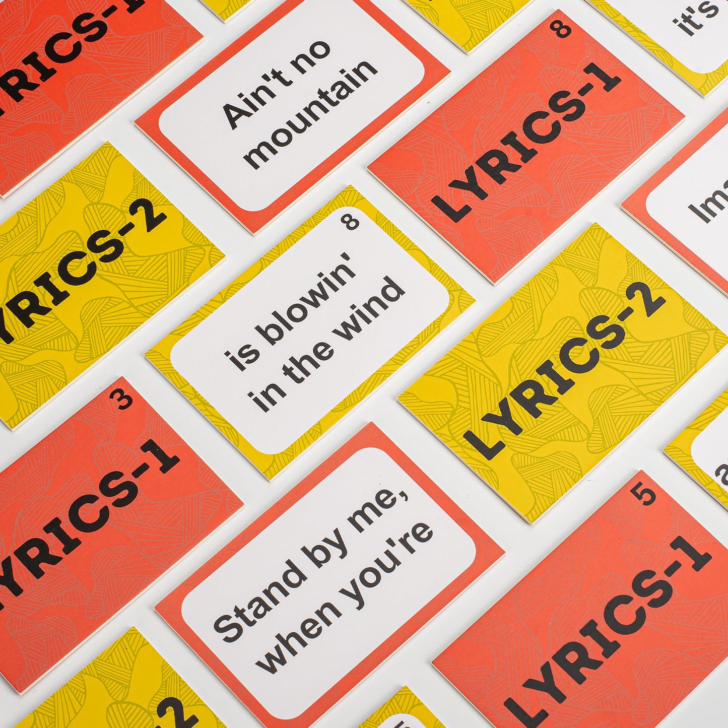 Colorful Assistex lyric matching card game cards spread showing large print song lyric prompts — Assistex via EOWD Autism Living