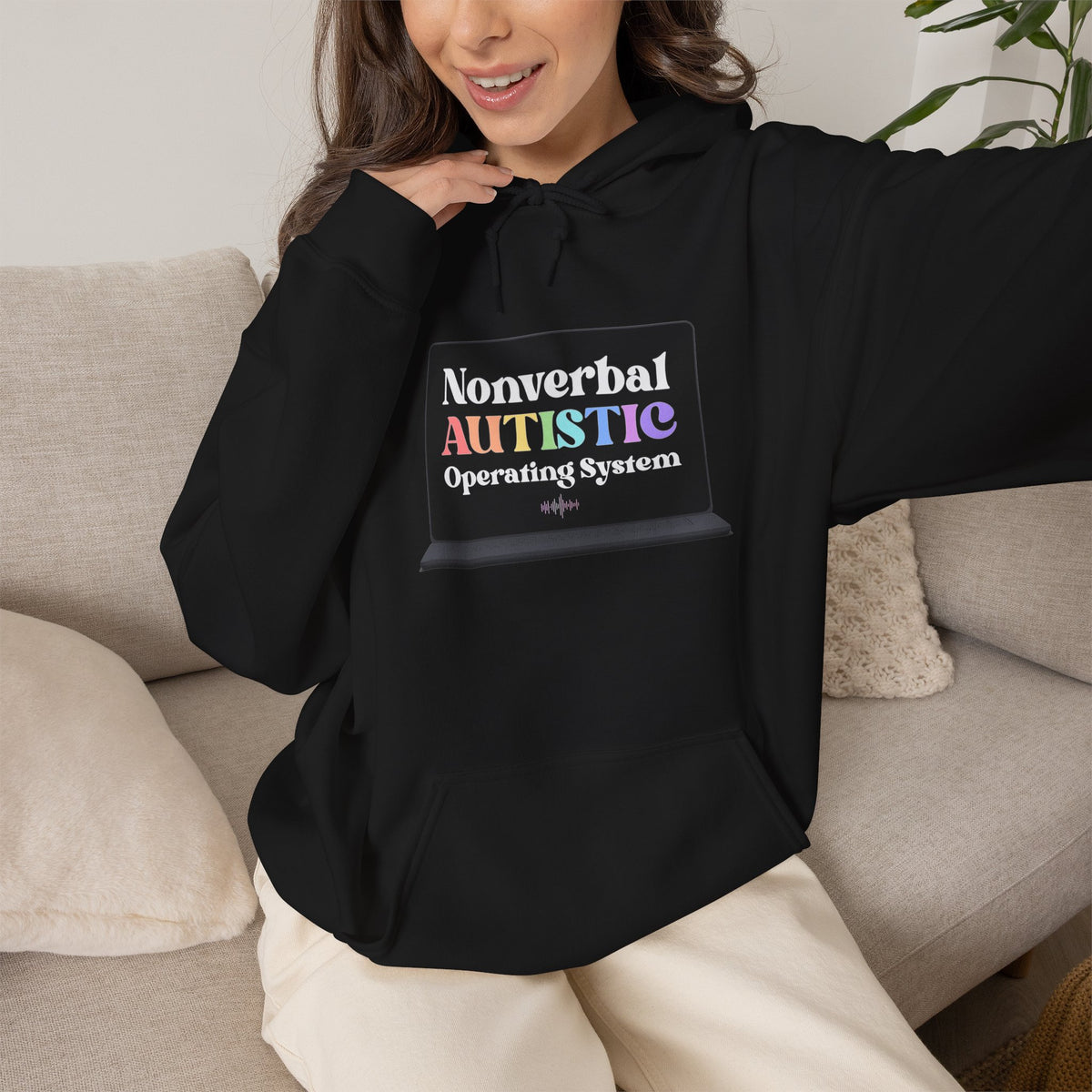 Person seated and wearing a black pullover hoodie with a small rectangular graphic centered on the chest — EOWD Autism Living