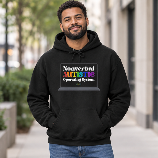 Adult man wearing a black pullover hoodie with the bold rainbow “Nonverbal AUTISTIC Operating System” laptop graphic on a city sidewalk — EOWD Autism Living