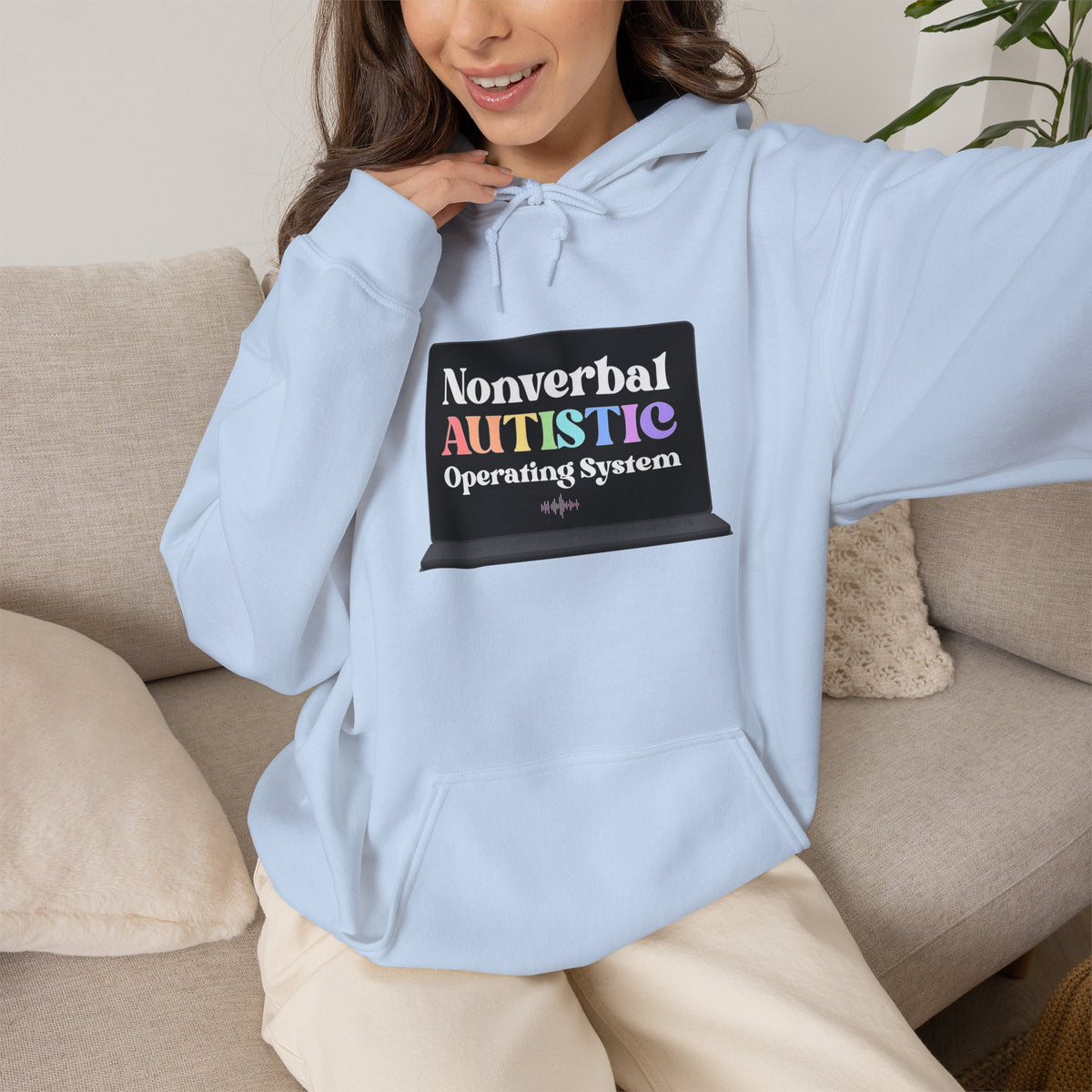 Person wearing a light blue pullover hoodie with a small rectangular graphic centered on the chest — EOWD Autism Living