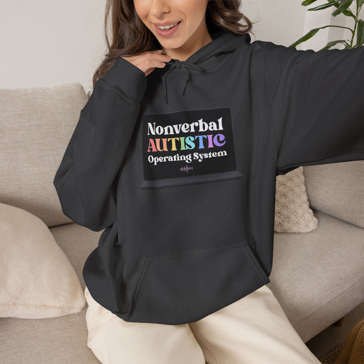 Person wearing a black pullover hoodie with a pastel “Nonverbal AUTISTIC Operating System” graphic on the front — EOWD Autism Living 