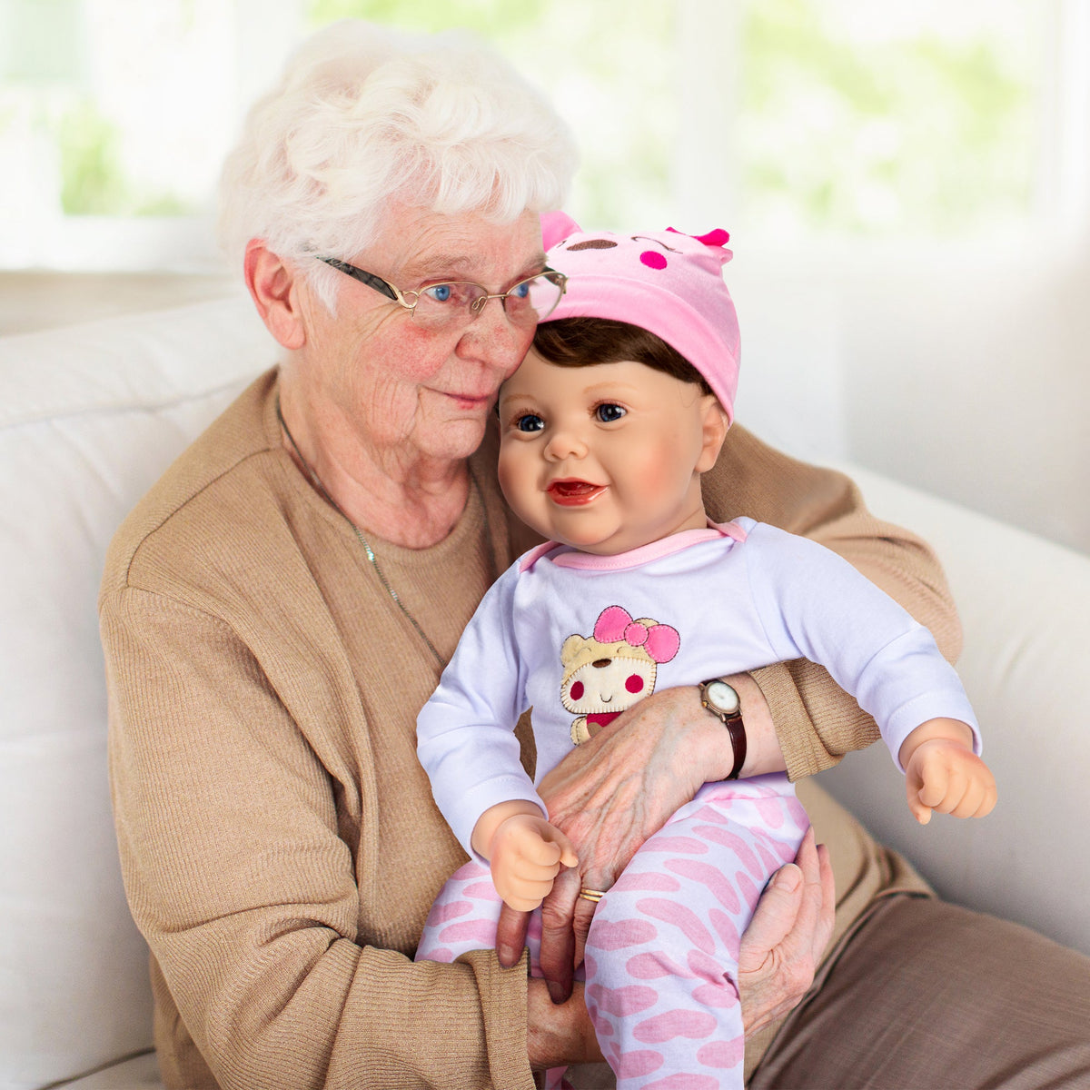 Older adult holding a brown-haired baby doll wearing a pink hat and pink-and-white clothing — Assistex via EOWD Autism Living