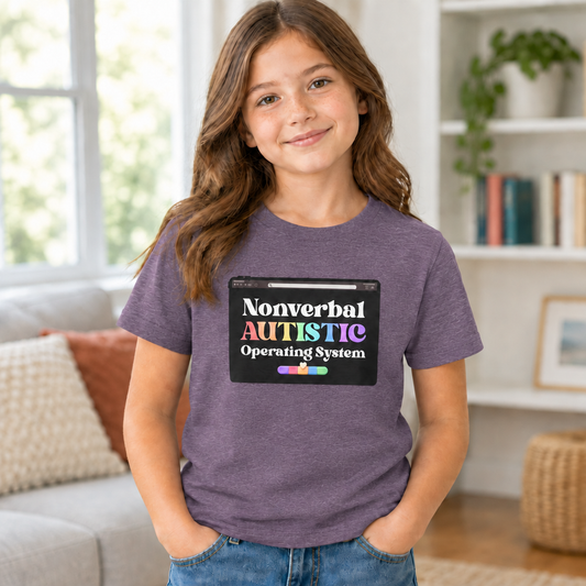 Young person wearing a Heather Team Purple youth T-shirt with subtle light heather texture and the “Nonverbal AUTISTIC Operating System” tablet graphic in a softly lit room — EOWD Autism Living.