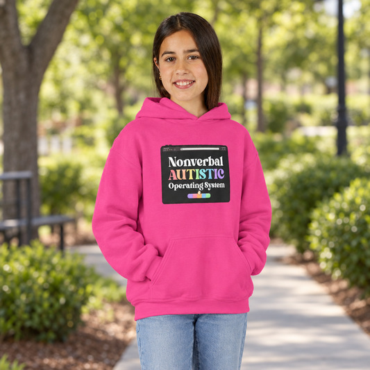 Young person wearing a Heliconia pink youth hoodie with the “Nonverbal AUTISTIC Operating System” tablet graphic on a park walkway — EOWD Autism Living