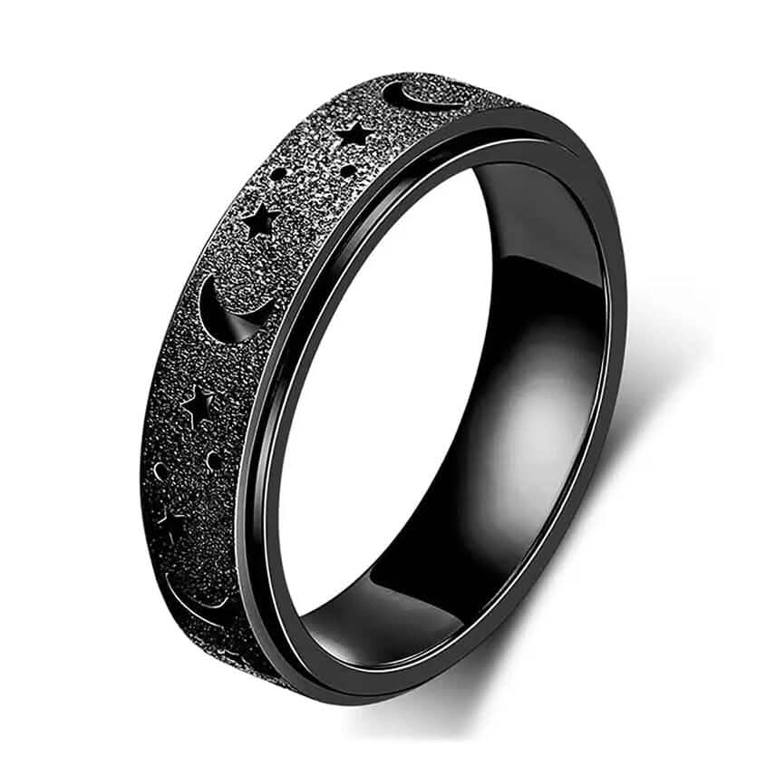 Close-up of black stainless steel rotatable moon and star fidget ring on white background — moon and star engraving detail visible — DailySale via EOWD Autism Living