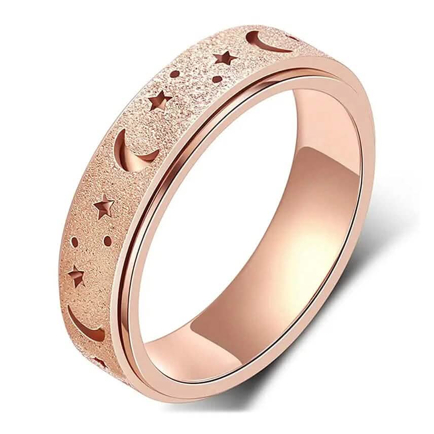Close-up of rose gold stainless steel rotatable moon and star fidget ring on white background — moon and star engraving detail visible — DailySale via EOWD Autism Living

